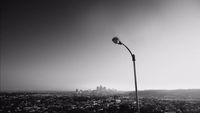 a black and white photo of a street light