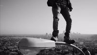 a man standing on top of a metal pole