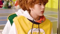 a man with red hair wearing a yellow jacket