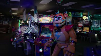 a video game room with a robot playing a video game