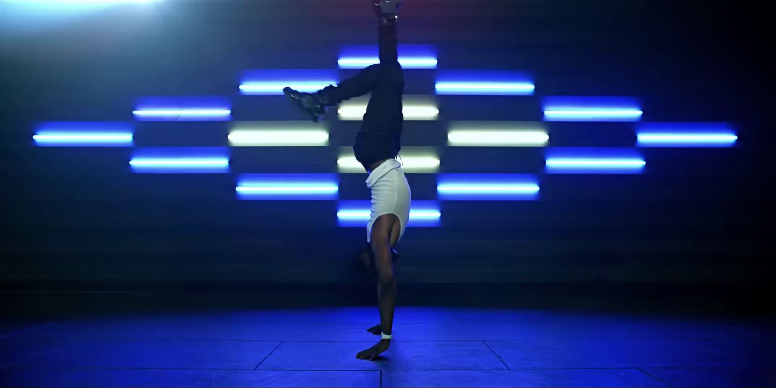 a person doing a handstand on a stage