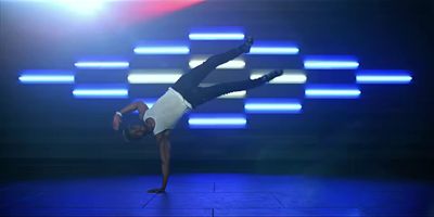 a man doing a handstand on a stage