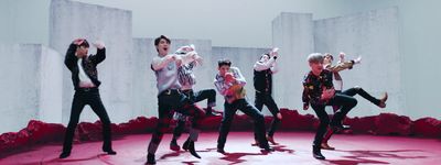 a group of young men standing on top of a pink floor