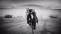 a man riding a skateboard across a parking lot