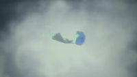 a kite flying through a cloudy sky on a cloudy day