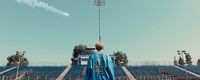 a man standing in front of a soccer field