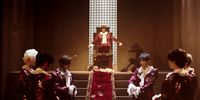 a group of people dressed in costumes standing on a set of stairs