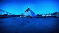 a very large triangular structure sitting in the middle of a parking lot