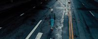 a person walking down a street in the rain