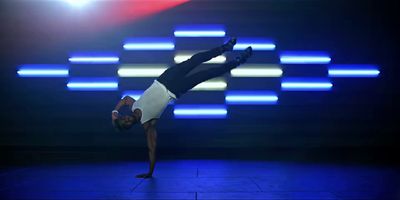 a man doing a handstand on a stage