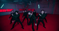 a group of young men dancing on a red carpet