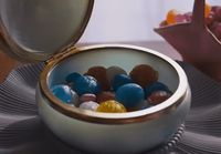 a bowl filled with candy sitting on top of a table