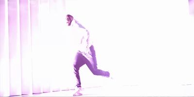 a man is dancing in a white room