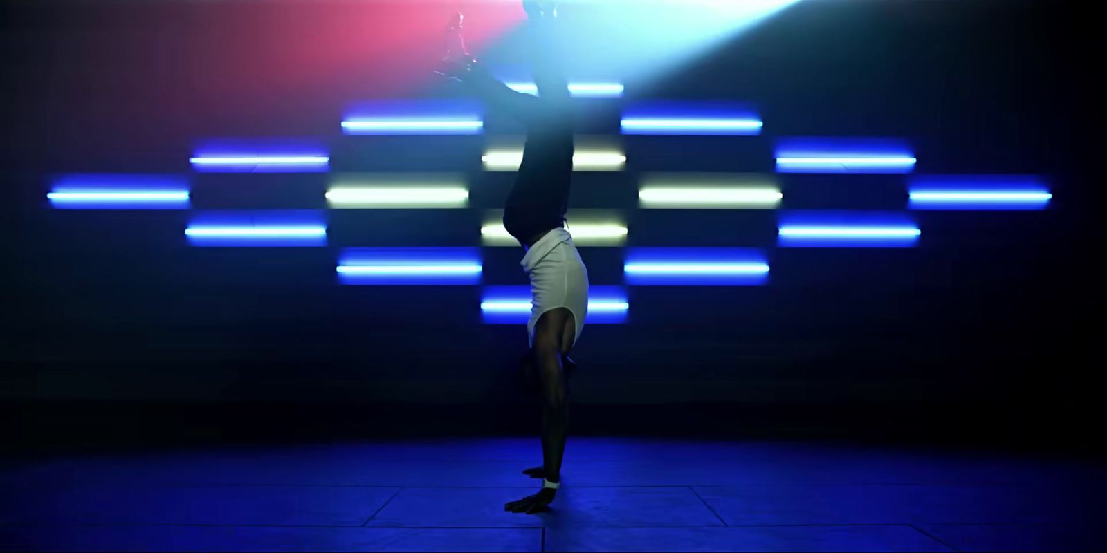 a person doing a handstand in a dark room