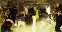 a group of young men dancing in a smoke filled room