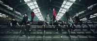 a group of young men sitting on top of metal steps