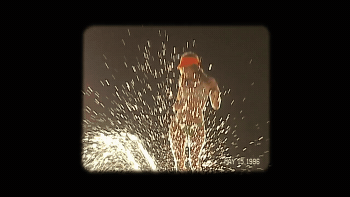 a man in a red hat is spraying water