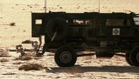 a military vehicle is parked in the desert