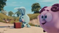 a cartoon bunny and a blue bunny playing with a red box