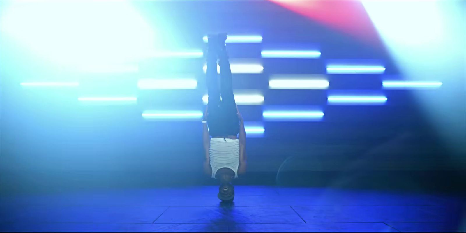 a person doing a handstand on a stage