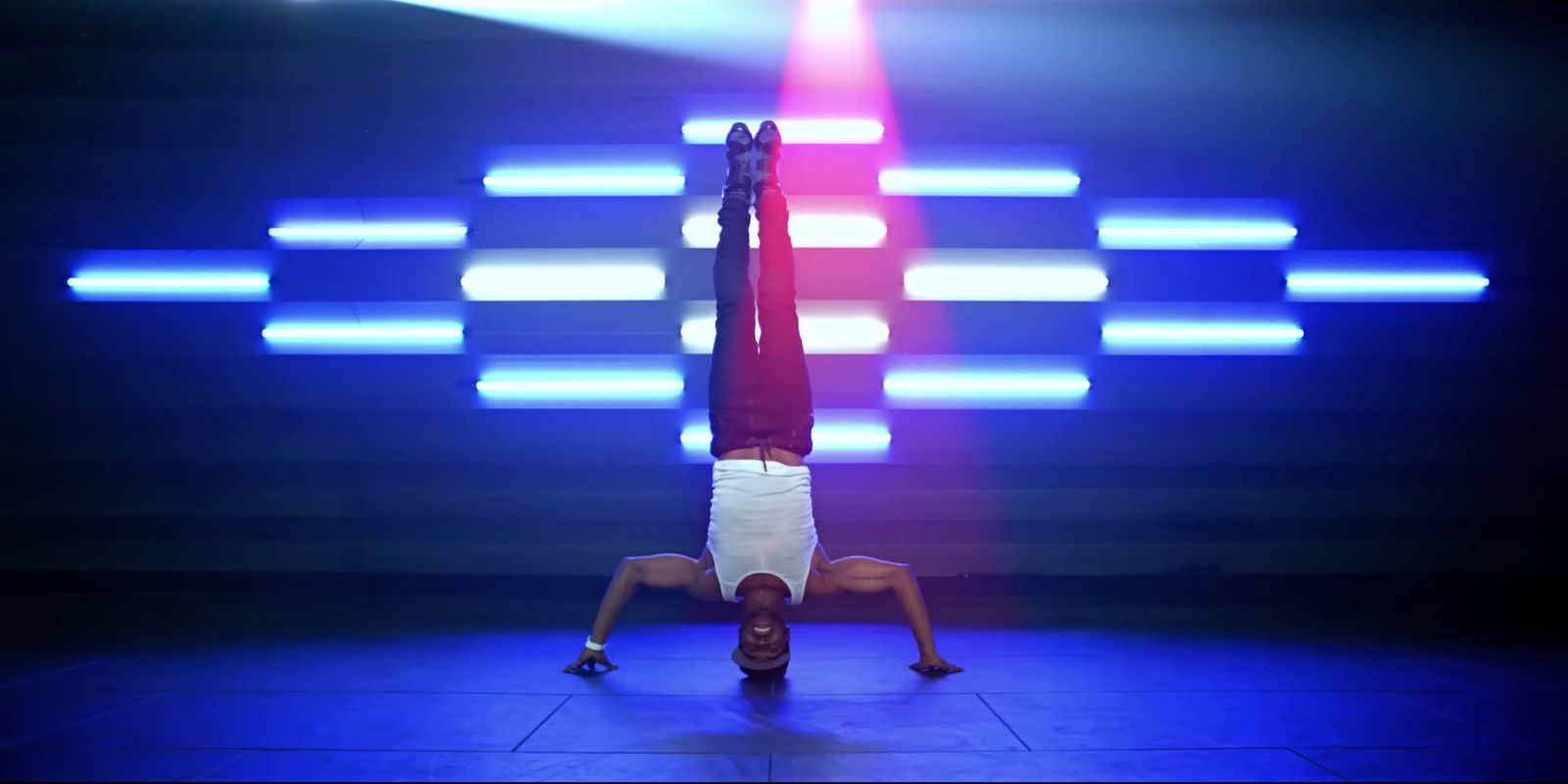 a person doing a handstand on a stage