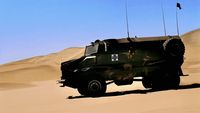 a military vehicle driving through the desert