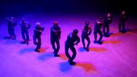 a group of people standing on top of a stage