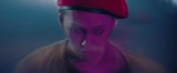 a blurry image of a man wearing a red hat