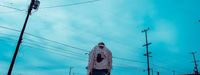 a man standing on a snowboard on a street