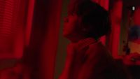 a person standing in a room with red lights