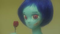 a close up of a doll with blue hair