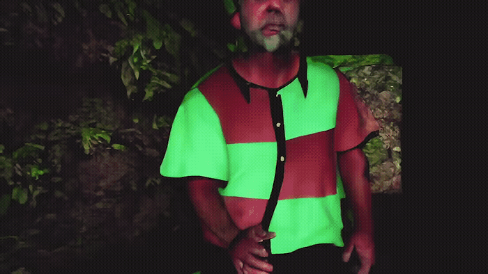a man wearing a green and red shirt