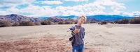 a man standing in the middle of a desert