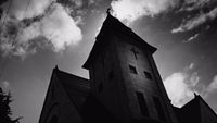 a black and white photo of a church steeple