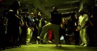 a group of people standing around a man on a skateboard