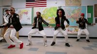 a group of young men dancing in a classroom