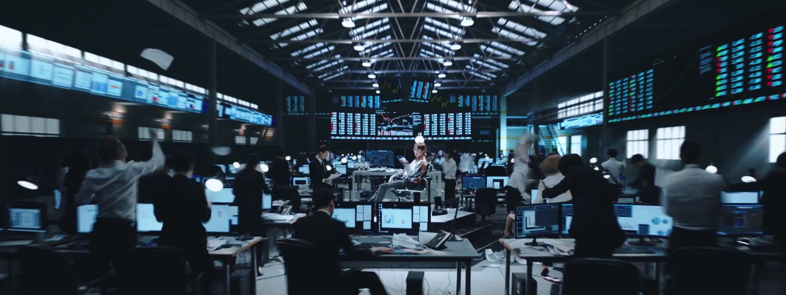 a group of people standing around a room filled with computers