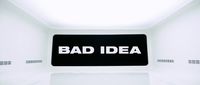 a bad idea sign in a white room