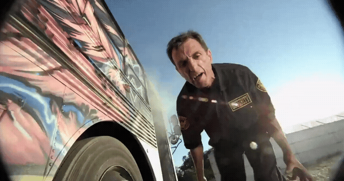 a man standing next to a van with graffiti on it