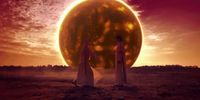 two women standing in front of a giant sun