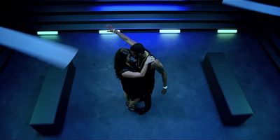 a man and a woman dancing in a dark room