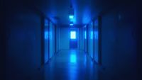 a long hallway with blue light coming from the ceiling