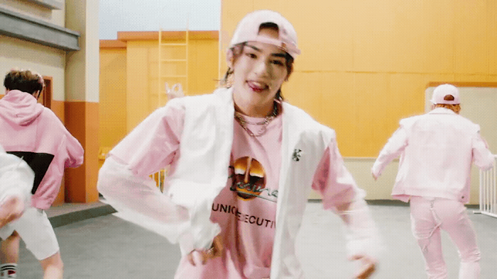 a group of young people in pink outfits