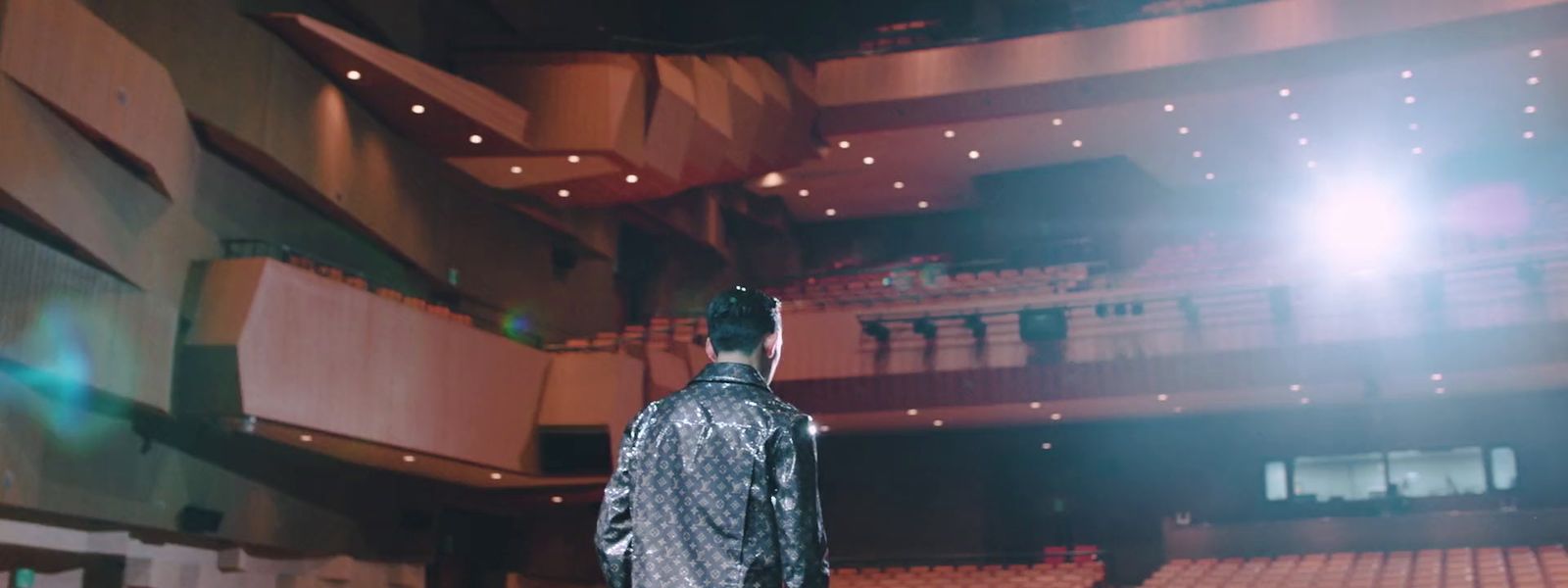 a man standing in front of a large auditorium