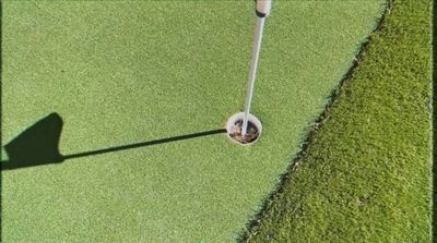 a golf ball on the green of a golf course