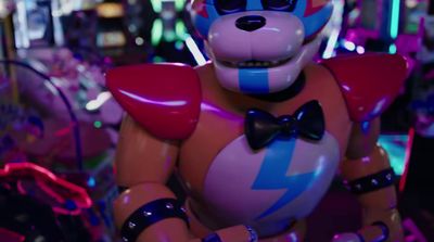 a robot with a bow tie standing in a room full of neon lights