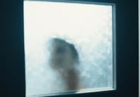 a blurry image of a person standing in front of a window