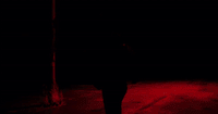 a man walking down a street at night