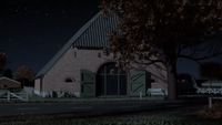 a house with a barn in the background at night