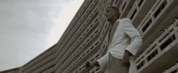 a man standing in front of a tall building